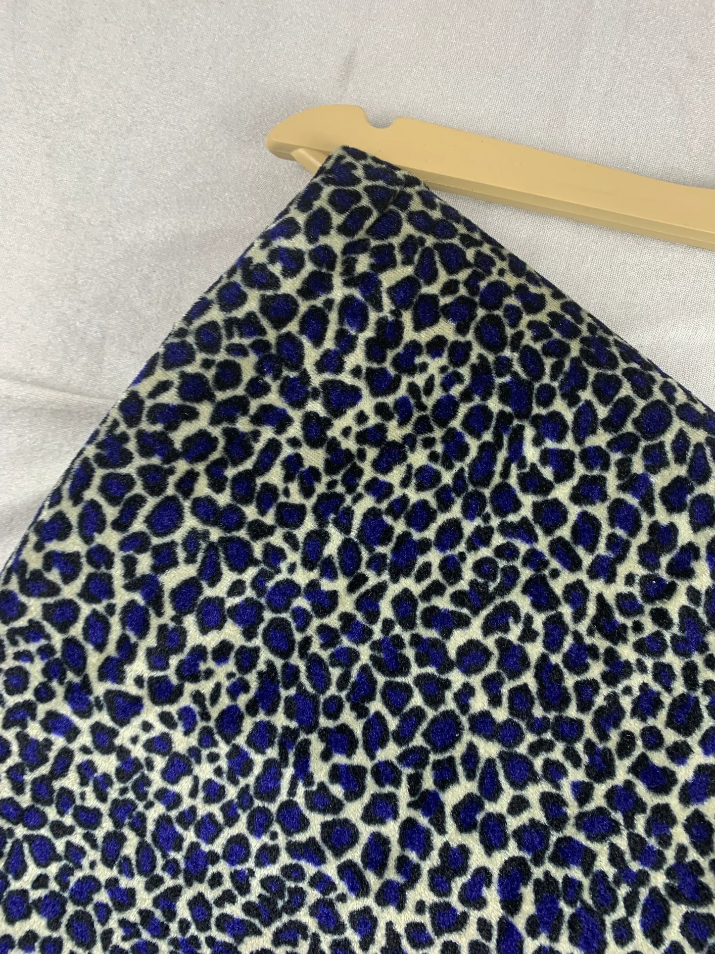 Blue and black leopard print lawn fabric for unstitched suits, displayed on hanger