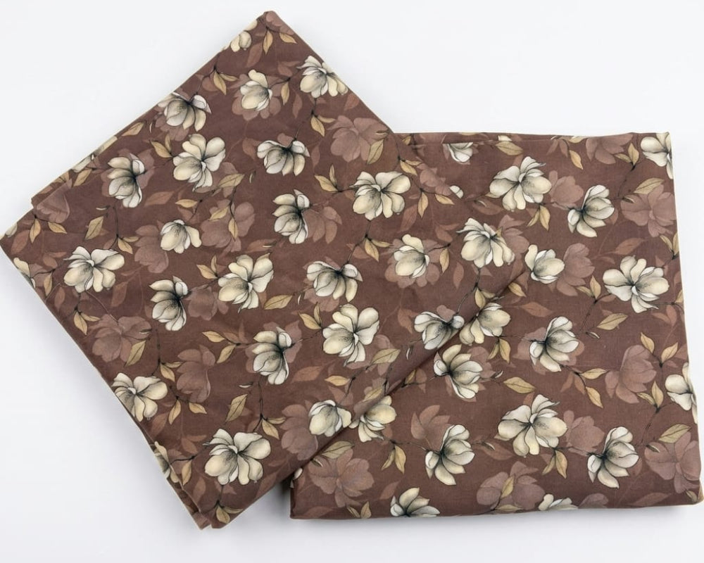 Brown floral fabric with cream flowers and leaves, ideal for home decor and sewing projects