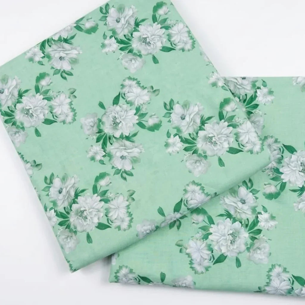 Mint green floral fabric with white roses and green leaves, ideal for sewing and crafting projects
