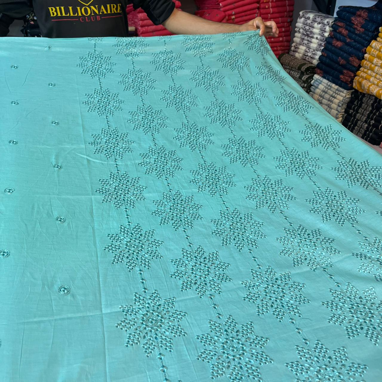 Mughalia Lawn 2-piece traditional embroidered fabric set with intricate floral designs, displayed in a well-lit studio shot.