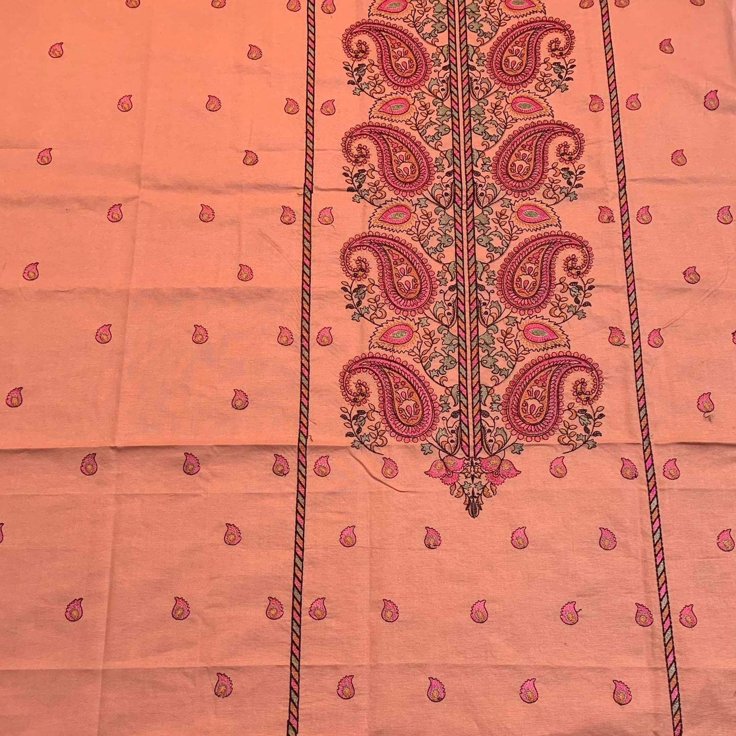 Peach lawn fabric with pink paisley print and floral border, ideal for designer ladies suits