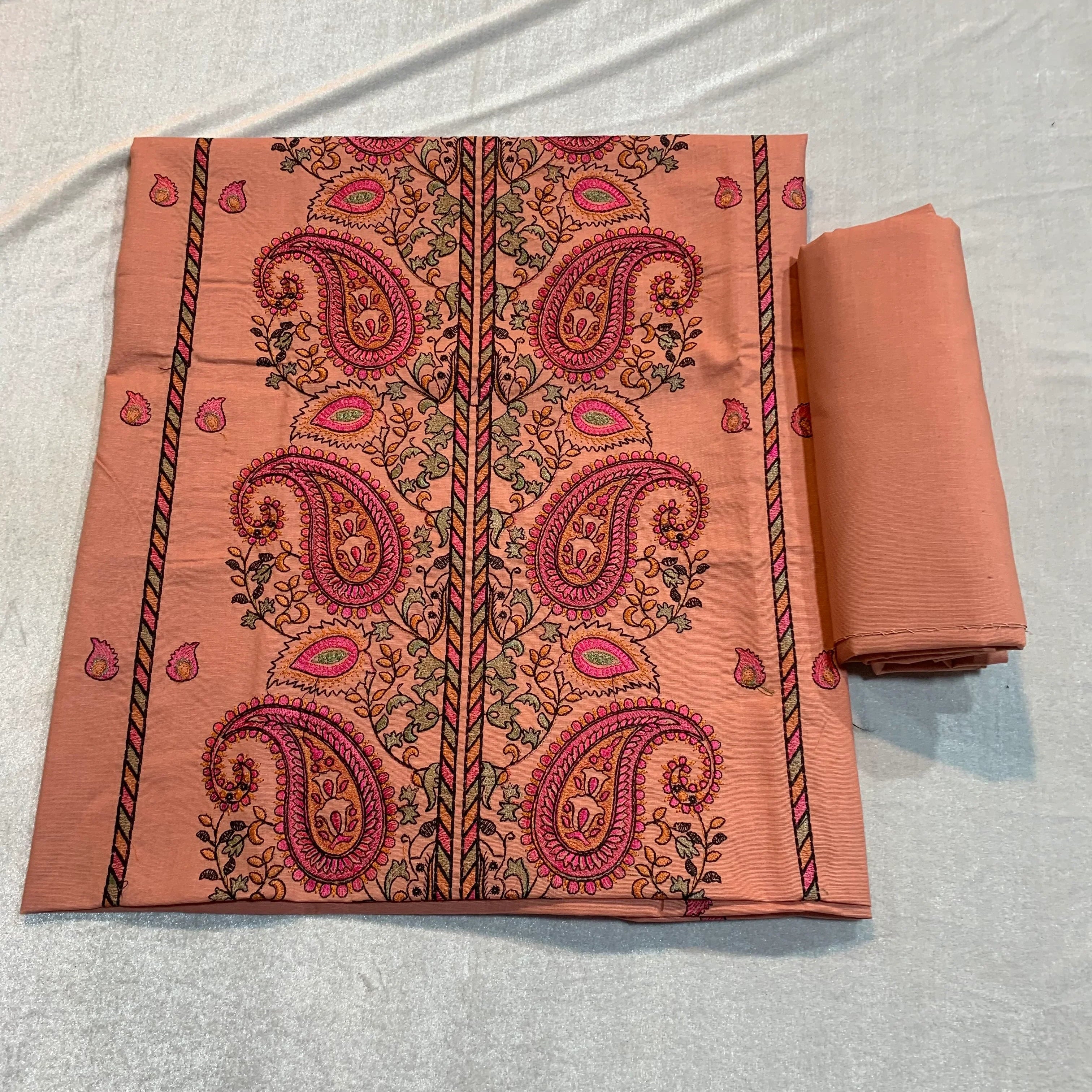 Peach lawn fabric with pink paisley print, perfect for unstitched suits and designer wear.