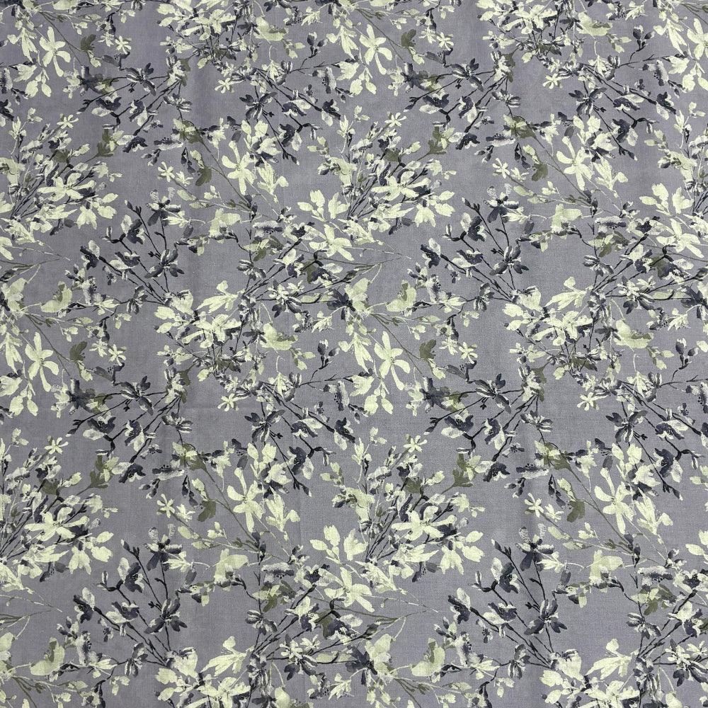 Grey fabric with delicate white and green floral print, ideal for home decor and upholstery