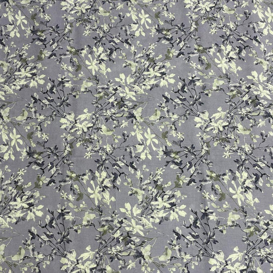 Grey fabric with delicate white and green floral print, ideal for home decor and upholstery