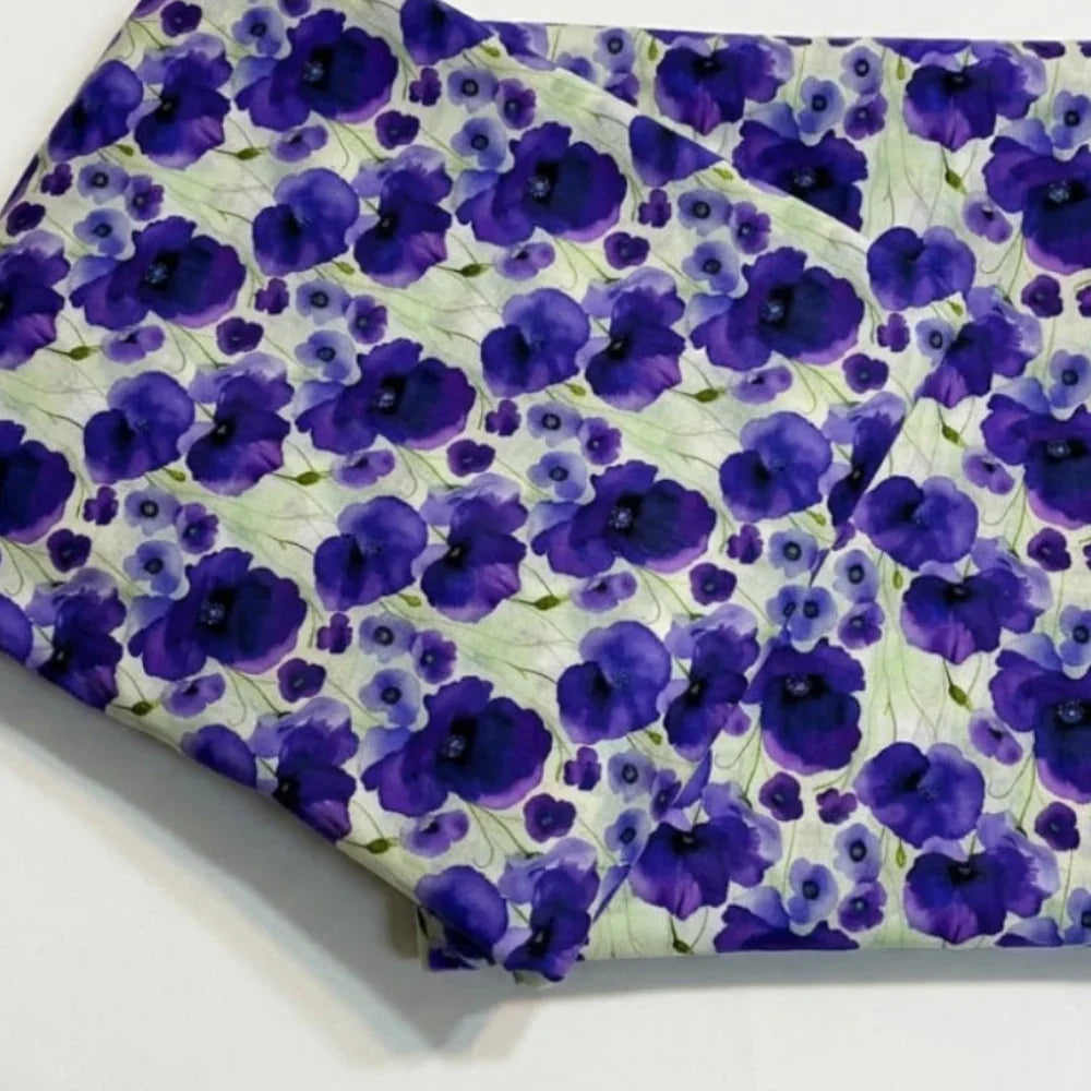Purple floral print fabric with watercolor poppies on light green background, ideal for sewing and crafts